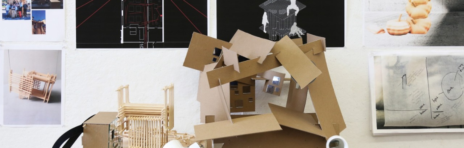 Sophomore studio work - models against a backdrop of renderings and drawings