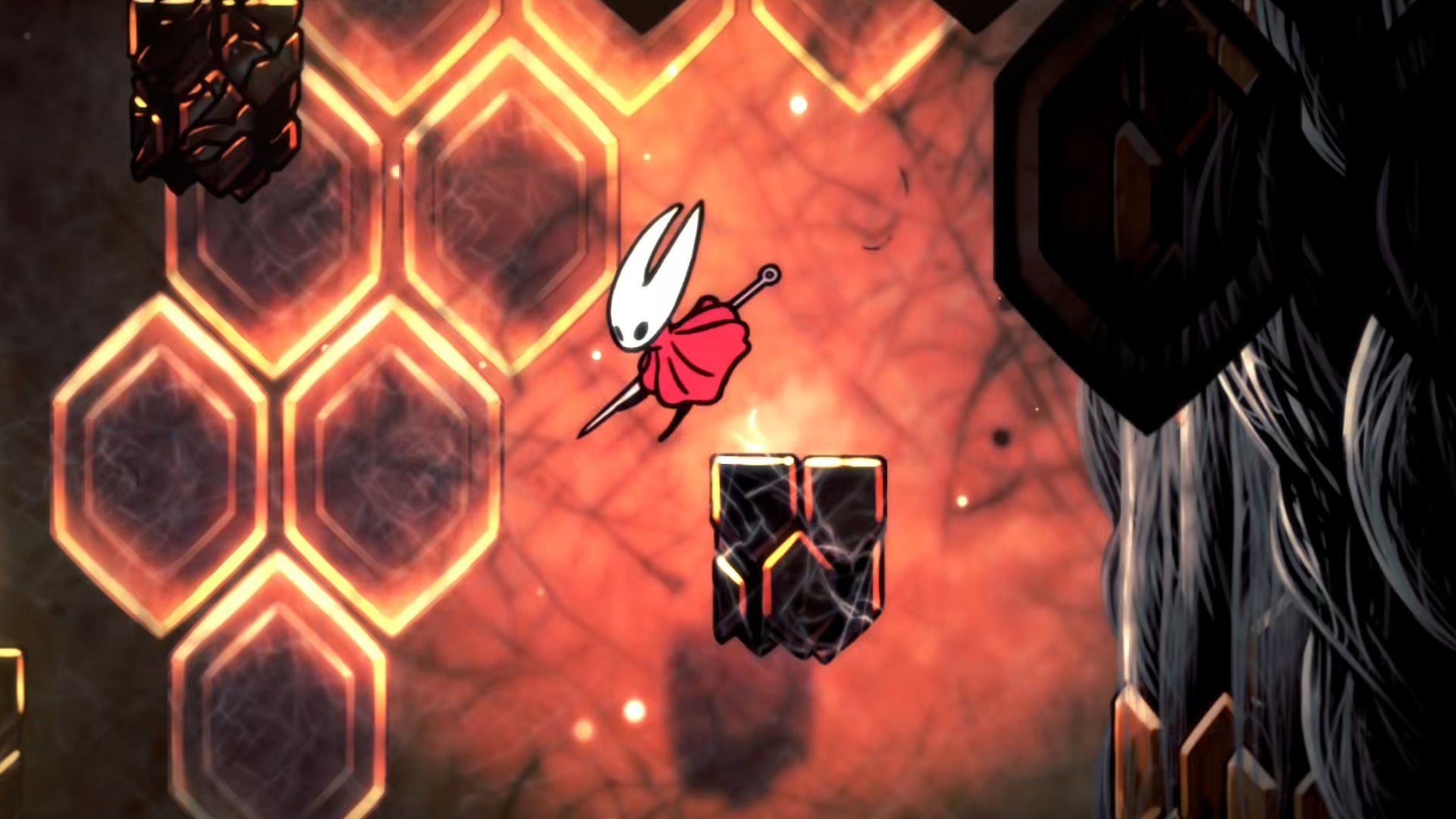 Hornet in Hollow Knight: Silksong dives down a tunnel in the Red Memory section of Act 3, against a backdrop of glowing orange hexagonal lights.